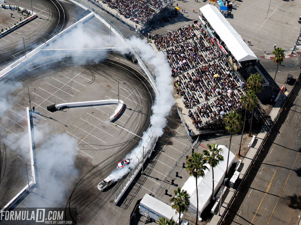 Aerial view of Formula DRIFT competition on the Streets of Long Beach with grandstands and tire smoke. Photo supplied by Formula DRIFT.